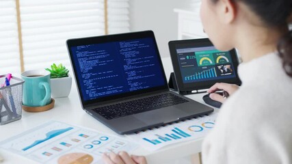 Back rear view of young asian woman, freelance data scientist work remotely at home coding programing on Big data mining, AI data engineering, IT Technician Works on Artificial Intelligence Project.