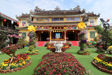 Hoi An, Vietnam, February 18, 2021: Main facade and gardens of the Phap Bao Temple. Hoi An, Vietnam