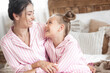 © olenachukhil - Mother and daughter having fun at home. Girls indoors.