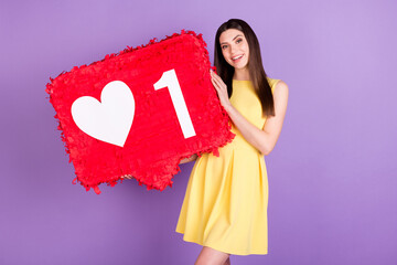 Wall Mural - Portrait of pretty cheerful girl holding in hands big large board like isolated over violet purple pastel color background