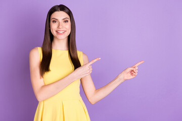 Wall Mural - Portrait of attractive cheerful girl demonstrating copy space way direction isolated over violet purple pastel color background