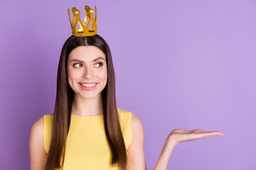 Wall Mural - Portrait of pretty cheerful girl wearing diadem holding on palm copy empty space isolated over violet purple pastel color background