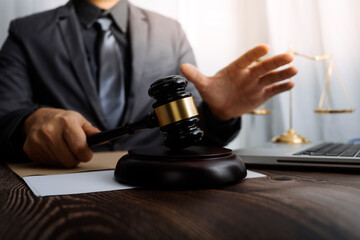 Business and lawyers discussing contract papers with brass scale on desk in office. Law, legal services, advice, justice and law concept