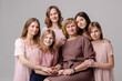 © Antipina - Woman's wife 8 march concept. Large family of women of different ages hugging portrait. Femininity support caring. Several female generations. Maternity is sisterhood feminism. Grandmother