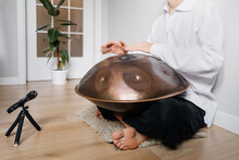 Man Playing On Hang Drum, Or Steel Drum, Hangpan, Modern Steel Music Instrument At Home. Recording Sound For Meditation Music For Relax. Close-up