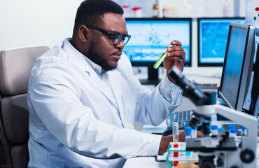 Canvas Print - Professional African-American scientist is working on a vaccine in a modern scientific research laboratory. Genetic engineer workplace. Future technology and science.