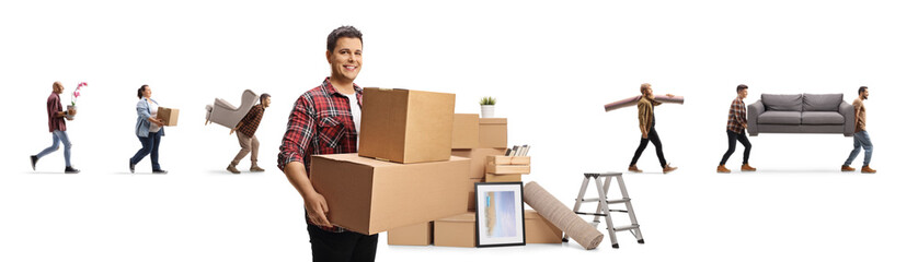 Wall Mural - Smiling man carrying boxes and other people moving household items