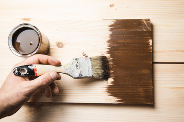 Wall Mural - man holding paint brush on wood