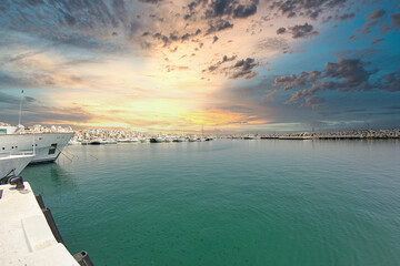 Dawn view of Puerto Banus marina with boats and white houses in Marbella town at sunrise, Andalusia, Spain