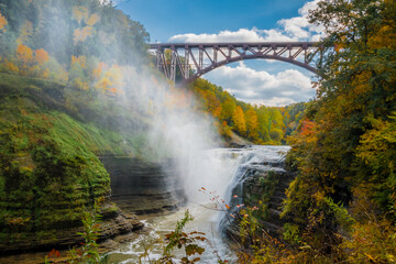  waterfall in autumn with a bridge  above the Genesee River , in Letchworth State Park, New York. 