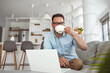 © Dragana Gordic - Technology, people and lifestyle concept - happy man with laptop computer drinking coffee or tea at home. Joyful bearded man working indoors at his living room