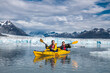 Happy couple enjoy kayaking near the glacier  and iceberg in Alaska