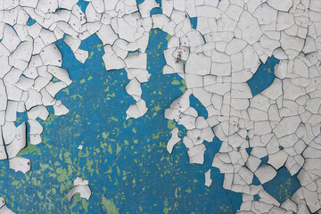 peeling paint on the wall. old concrete wall with cracked flaking paint. weathered rough painted sur