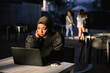 © Gerald R Carter Jr/Creative Flame - Professional Muslim businesswoman working remote at local coffee shop