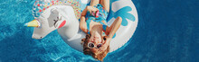 Cute Adorable Girl In Sunglasses With Drink Lying On Inflatable Ring Unicorn. Kid Child Enjoying Having Fun In Swimming Pool. Summer Outdoors Water Activity For Kids. Web Banner Header.