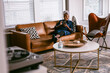 © Gerald R Carter Jr/Creative Flame - Black senior woman reading news on cellphone at home