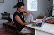 © Gerald R Carter Jr/Creative Flame - Creative woman works from home remotely using laptop