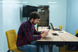 © Andrii - Young man working at the office table in the office. Business, co-working