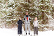 © Ekaterina Yakunina/Westend61 - Father and children skiing against trees in forest during winter