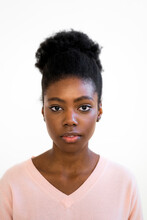 Young Woman Staring While Standing Against White Background
