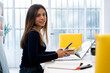 © Giorgio Fochesato/Westend61 - Smiling student with laptop holding mobile phone while sitting on table at home