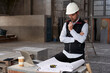 © Veam/Westend61 - Male architect thinking while analyzing blueprint on table in building