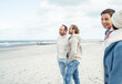 © Uwe Umst√§tter/Westend61 - Group of adult friends standing and talking on coastal beach