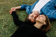 © Xavier Lorenzo/Westend61 - Smiling couple lying on lawn