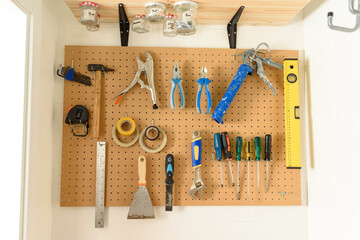 various construction tools hanging on the wall. High quality photo.