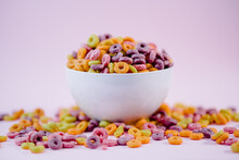 From Above Pile Of Colorful Cereal Rings In Bowl Prepared For Breakfast Placed On Violet Table In Studio