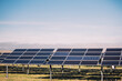 © Ramon Lopez/ADDICTIVE STOCK - Modern solar panels installed in field against cloudy sky in photovoltaic power station