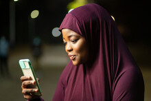 Image Of Traditional  African Woman With A Smart Phone- Local Muslim Lady Surfing On Social Media- Outdoor Communication Concept