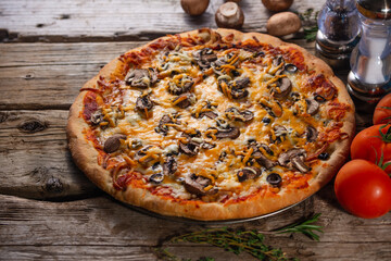 Wall Mural - Pizza with mushrooms and cheese on a wooden background