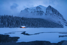 Blue Hour At A Mostly Frozen Lake Louise During The Winter. This Lake Is An Iconic Spot In The Canadian Rockies.