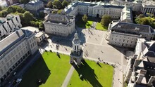 Stunning Aerial Reveal Of Trinity College In Dublin. People Crossing Squares In University Complex. Beautiful Summer Sunny Day