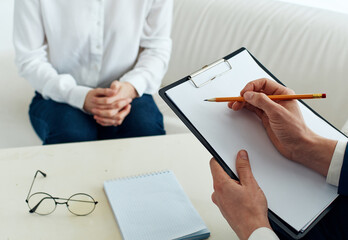 male psychologist with documents and woman indoors