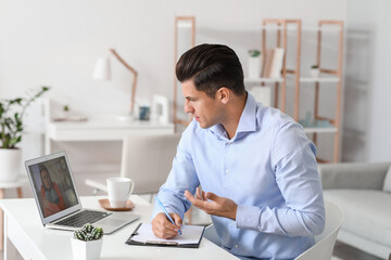 Wall Mural - Psychologist working with patient online while sitting in office