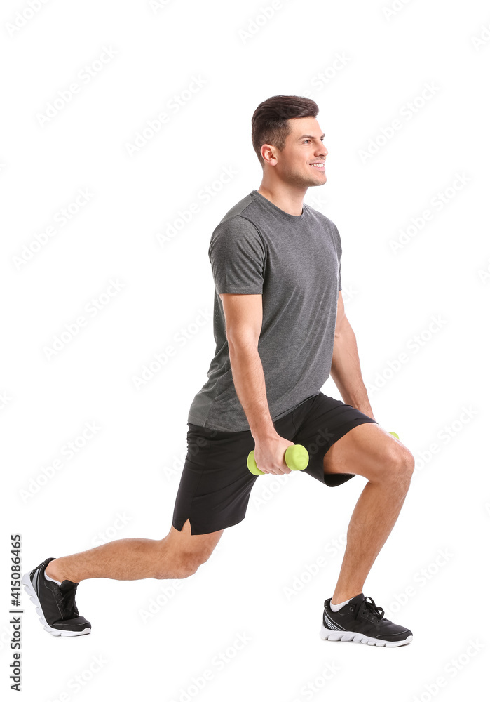 Sporty young man training with dumbbells on white background