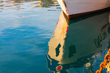 Poster - Italy, Sicily, Agrigento Province, Sciacca. Reflection of a fishing boat in the harbor of Sciacca, on the Mediterranean Sea.