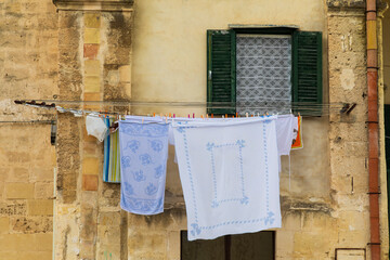 Canvas Print - Italy, Basilicata, Province of Matera, Matera. Laundry drying outside an old building.