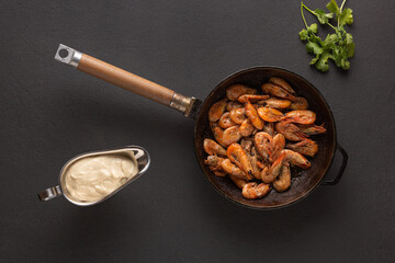 Fried shrimps in a pan with cilantro, close up