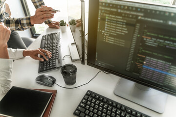 Wall Mural - programmer writing program code with two monitors and working on a new software or hacker programmin