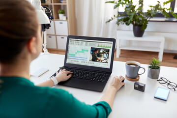 Sticker - technology, post production and vlog concept - close up of woman working in video editor program on laptop computer working at home office