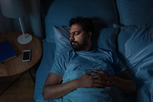 People, Bedtime And Rest Concept - Indian Man Sleeping In Bed At Home At Night