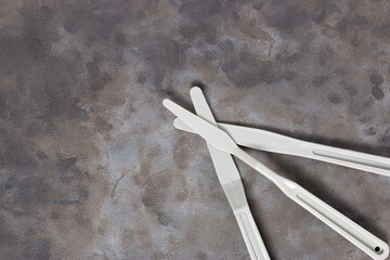 Wall Mural - Top view of painting tools (plastic spatula) on a painted canvas