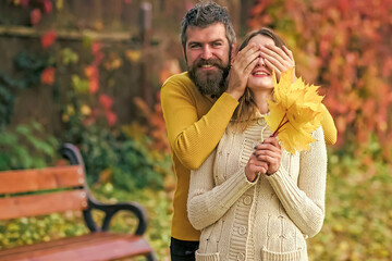 Wall Mural - Couple in love play in autumn park. Love relationship and romance. Autumn happy couple of girl and man outdoor. Nature fall season.