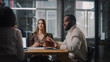 © Gorodenkoff - Young Creative Team Meeting with Business Partners in Conference Room Behind Glass Walls in Agency. Colleagues Sit Behind Conference Table and Discuss Business Opportunities, Growth and Development.