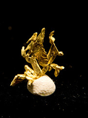 Sticker - Vertical shot of native gold isolated on a black background