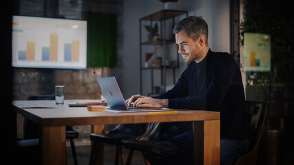 Aufkleber - Handsome Caucasian Male is Working on Laptop Computer while Sitting Behind a Conference Table in Meeting Room in an Creative Agency. Project Manager is Busy With Business Strategy and Development.