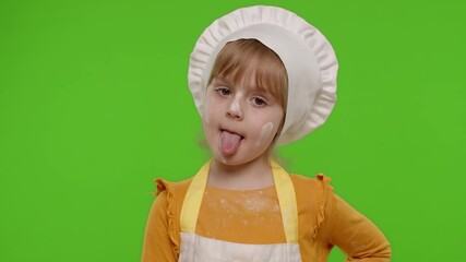 Wall Mural - Funny Caucasian preschooler child girl dressed as cook chef baker in apron dancing, fooling around, making silly funny faces, showing tongue. Isolated on chroma key background. Slow motion. 4k footage